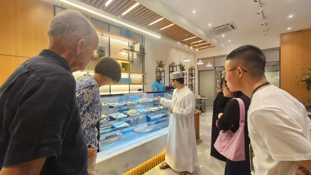 Visitors looking at food displayed in a shop